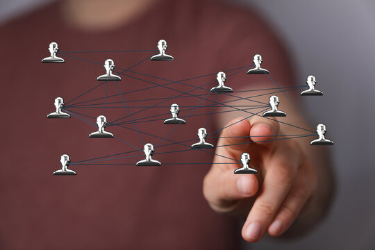 Concept of the global network with a hand pointing towards the center of a connected network of people