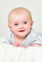 bright portrait of adorable baby.  baby in the interior of the bedroom.