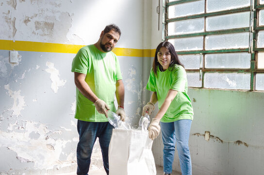 Portrait of two smiling and happy volunteers cleaning.Recycle concept.Earth Day concept.
