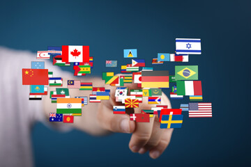 A hand interacts with a collection of world flags. Representing globalization, international relations, travel, and unity. Perfect for concepts