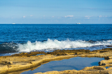 Rocky shoreline and waves in Marsaskala, Malta