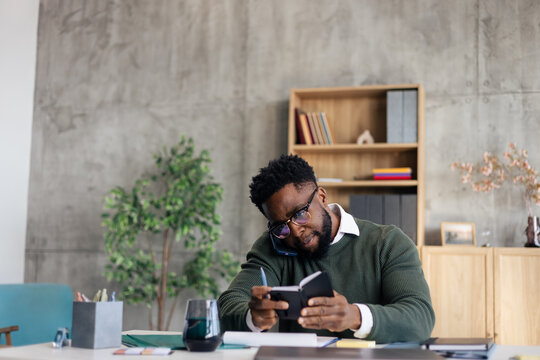 Busy entrepreneur multitasking on phone call in office