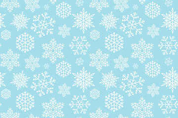 Blue Christmas background with white snowflakes pattern. Winter seamless pattern with snowflakes on a blue background.