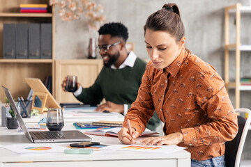 Colleagues collaborating at modern office workspace