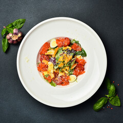 Appetizing Caesar salad with salmon and croutons. In a white round plate, on a stone background....