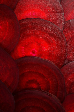 Round textured slices of beetroot. Macro photo of beetroot. Top view. Vertical photo.