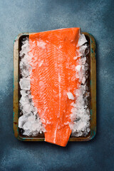 raw salmon or trout sea fish fillet on ice. Top view.