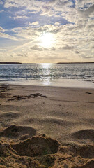 Beautiful sunset. Surf waves on Playa de las Americas sandy beach.  Tenerife, Canary Islands. Spain.