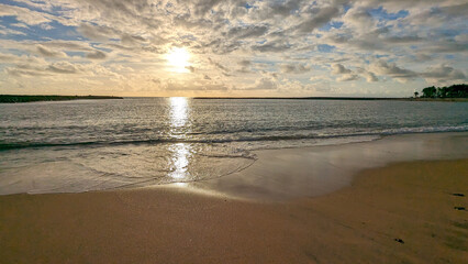 Beautiful sunset. Surf waves on Playa de las Americas sandy beach.  Tenerife, Canary Islands. Spain.