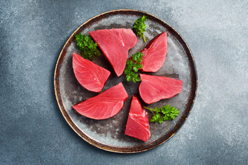 Stone plate with fresh tuna steaks. Seafood, healthy food. Close up, top view.
