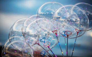 Balloons with transparent and illuminated holder handles