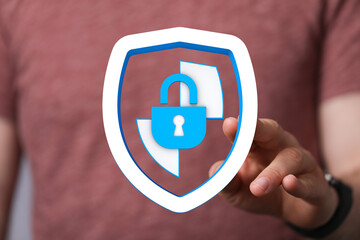 Hand holding a shield icon with a padlock, representing data security, cyber protection, and...