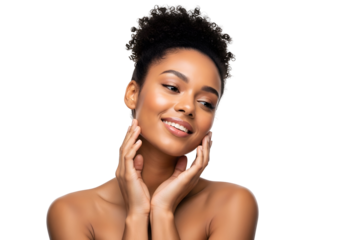 Beautiful young Black woman with a confident radiant smile and glowing healthy skin gently touching her face expressing natural beauty skincare and self-care concepts