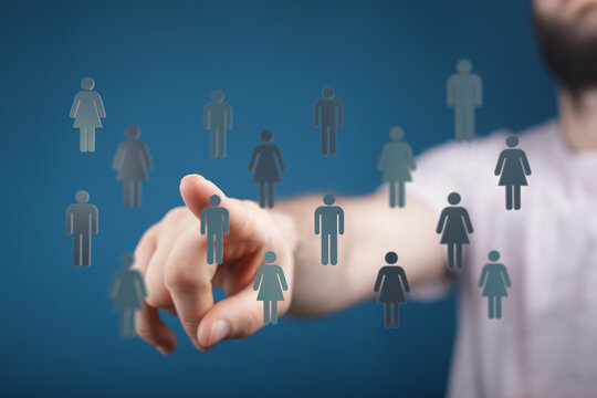 Concept of social network and communication technology. Hand pointing at a team of people icons