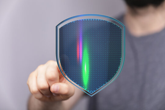 Hand pointing at a digital shield representing security and data protection. Concept for cybersecurity, privacy, and online safety. I - Powered by Adobe