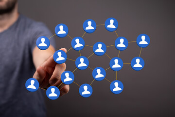 Visual representation of network, connections, teamwork, and communication. A hand touches a digital network wi