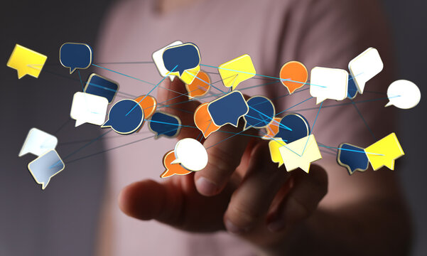 Hand reaching towards a network of digital message bubbles, representing communication, social media, and onlin