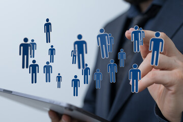 Businessman holding digital human icons representing a concept of human network, social media, community and te