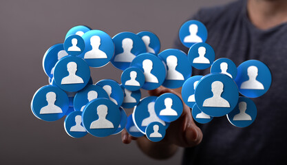 Hand reaching towards a collection of user icons, symbolizing connection, networking, and social media influence, perfect for illustrating onlin