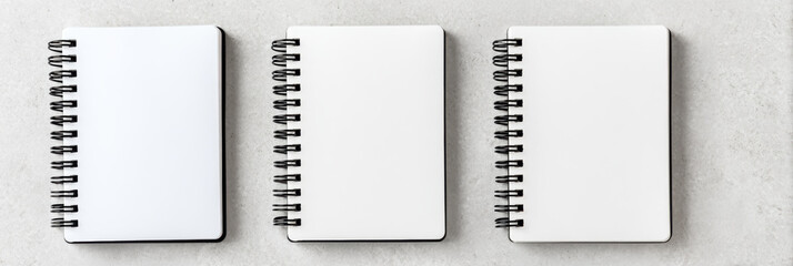 Calm flat lay of blank spiral notebook with white page for mock up or template design. This clean notepad arrangement provides ample copy space for creative ideas