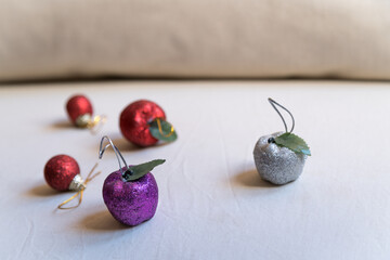 Christmas decorations made from purple, red, and silver apples.
