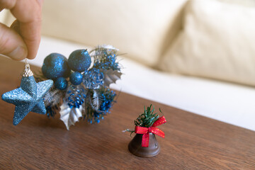 Hand holding blue glitter star christmas ornament