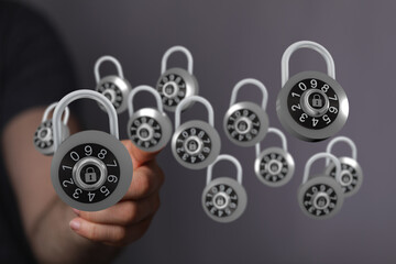 Hand holding multiple floating padlocks representing concepts of security, protection, and digital safety.  Sec