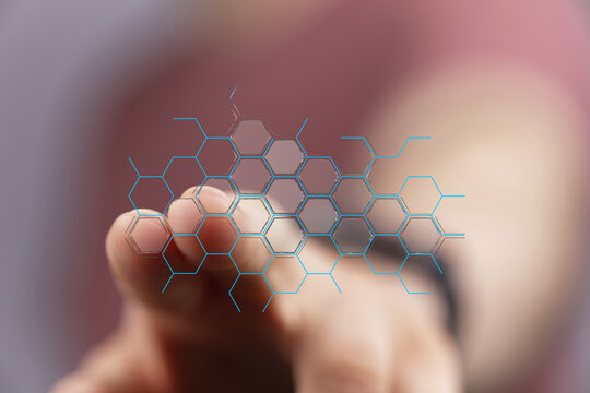 Abstract image of finger interacting with a digital hexagon network, representing connection, innovation, and technology.