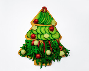 Christmas Tree Salad with Mozzarella Balls and Cherry Tomatoes on Wooden Board