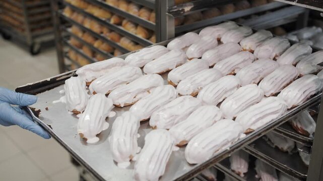 Freshly Iced Eclairs On Bakery Tray, Mass Production.