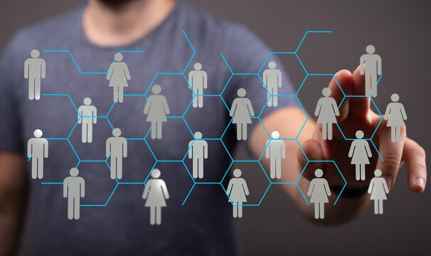 Concept of network connection between people. Hand touching screen with people icons and hexagons. Concept of teamwork, social media, community