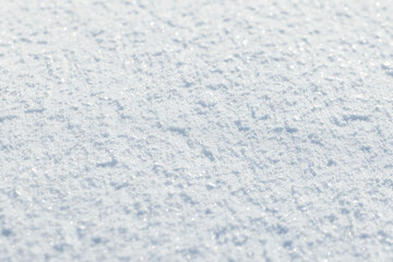 White snow surface shines in sunlight. Close up photography,