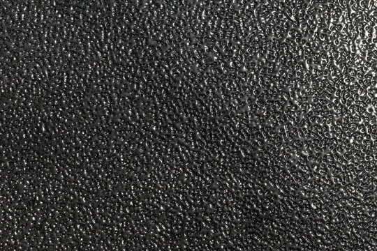 Steel surface with shiny black powder coating, abstract industrial photo texture