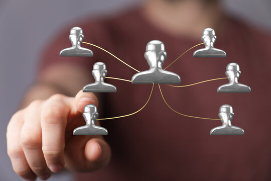 Visual of a person pointing towards a network structure, symbolizing teamwork, connectivity, and business relationships.
