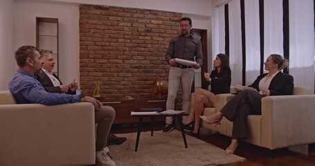 Multigenerational business team collaborating on a project in a modern office. They are discussing ideas and strategies for success.