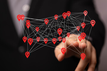 Hand interacting with a digital network of interconnected location points.  Illustrates global connectivity, networking, and data visualiz