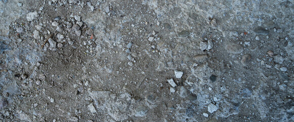 Close-up of a gray-black lava texture on the ground. Porous, cracked, and stony, perfect as a stock texture or photo background. Impression of molten rock.