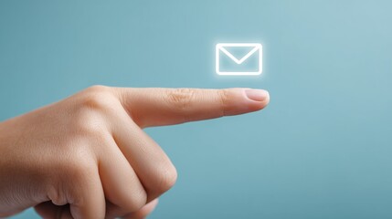 A woman's hand with an outstretched index finger on a blue background, above the finger is a white envelope icon with a glow effect. The finger indicates the direction of the letter.