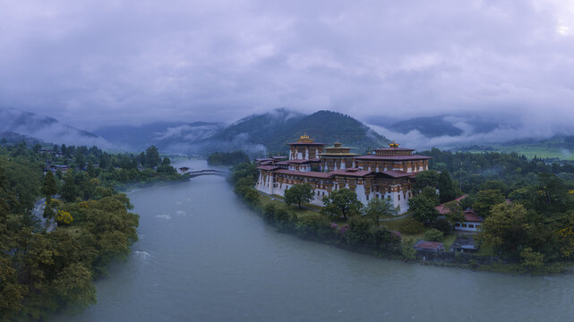 Aerial view of the majestic Punakha Dzong fortress where the Pho Chhu and Mo Chhu rivers converge under a blanket of mist, Punakha, Punakha, Bhutan.