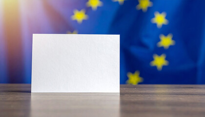 Blank paper note on wooden table, blurred European Union flag in background, copy space for text