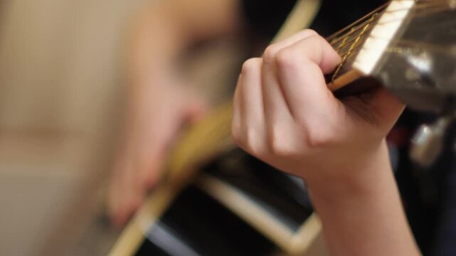 Close-up of Child's Hands Playing Acoustic Guitar, Kids Learning Guitar Concept