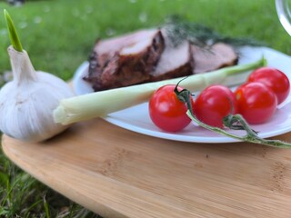 Grilled meat on a board and fresh vegetables