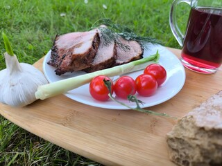 Grilled meat on a board and fresh vegetables