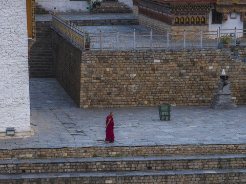 Haa, Bhutan - 25 September 2025: Aerial view of Haa Dzong, where warm terracotta robes stand out against the cool grey stone, under the soft light.