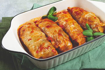 Stuffed cabbage rolls with minced meat, in tomato sauce, top view, without people, in the spotlight.
