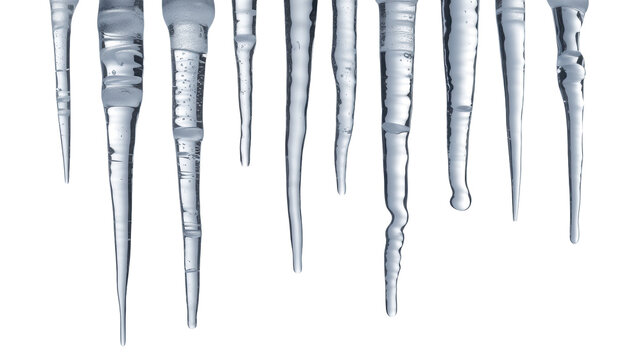 A close up abstract view of multiple sharp icicles hanging down from an unseen surface against a deep black background isolated on transparent background