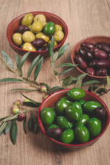 a mixture of olives, varieties of chalkidiki, Verdi giganti and Kalamata, in a bowl, top view, no people,