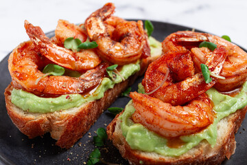 sandwiches with avocado and caramelized shrimp, micro-greens, breakfast, on a plate, top view, homemade, no people,