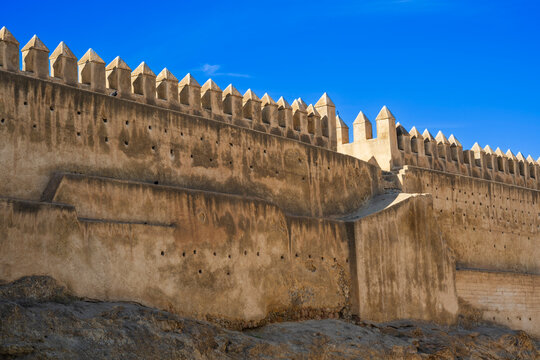 Historical stone fortress towers under a clear blue sky with architectural details. Fez, Fez-Meknes, Northern Inland Morocco