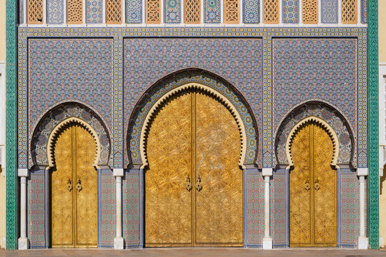 Ornate Moroccan architecture featuring intricate tilework and golden doors under archways. Fez, Fez-Meknes, Northern Inland Morocco